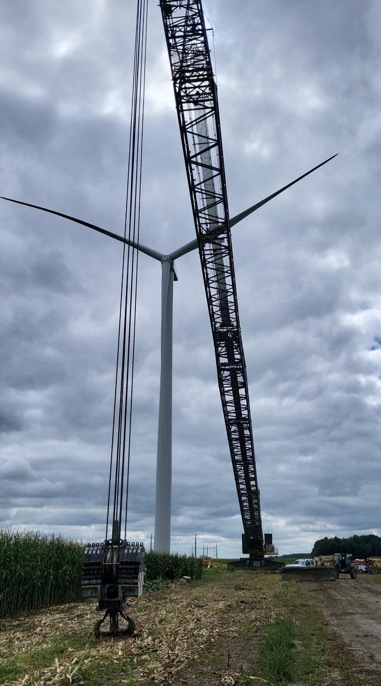 Crawler crane next to wind turbine on a wind farm