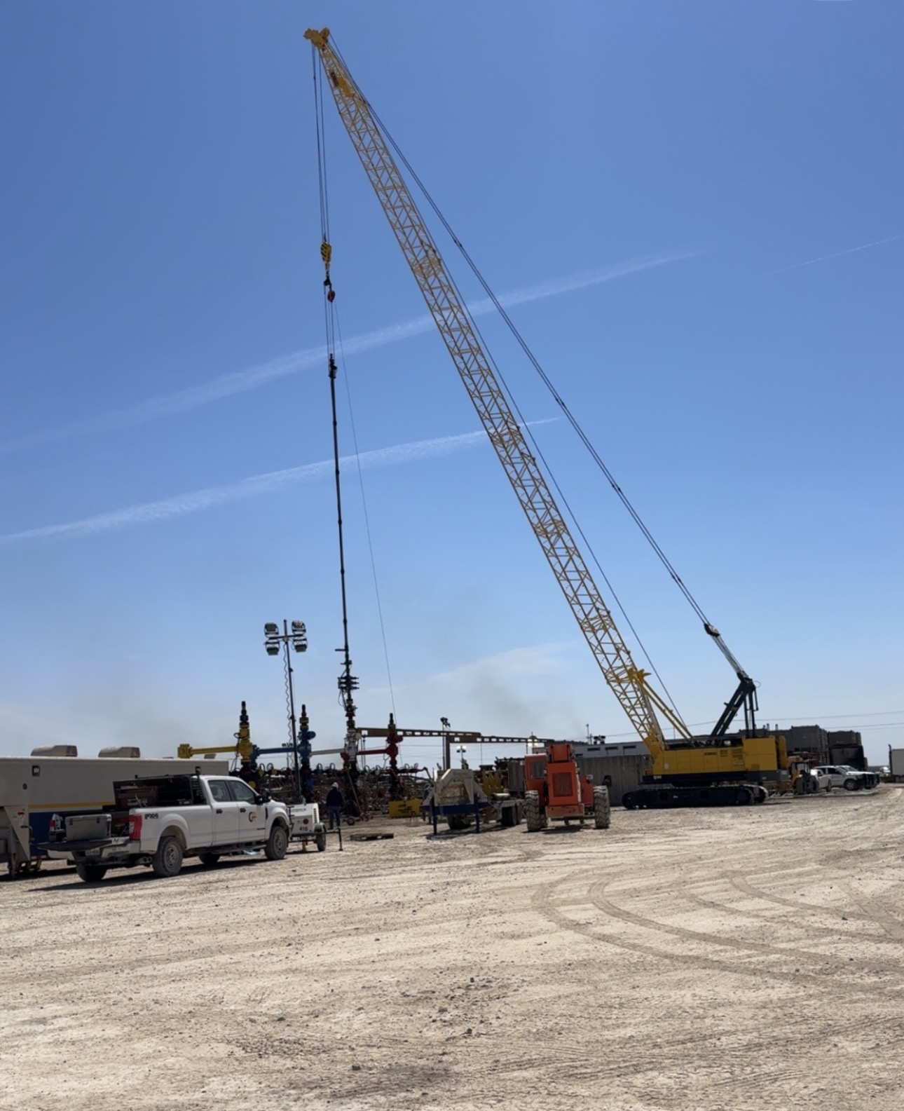 Crawler crane supporting wireline operations over a wellhead